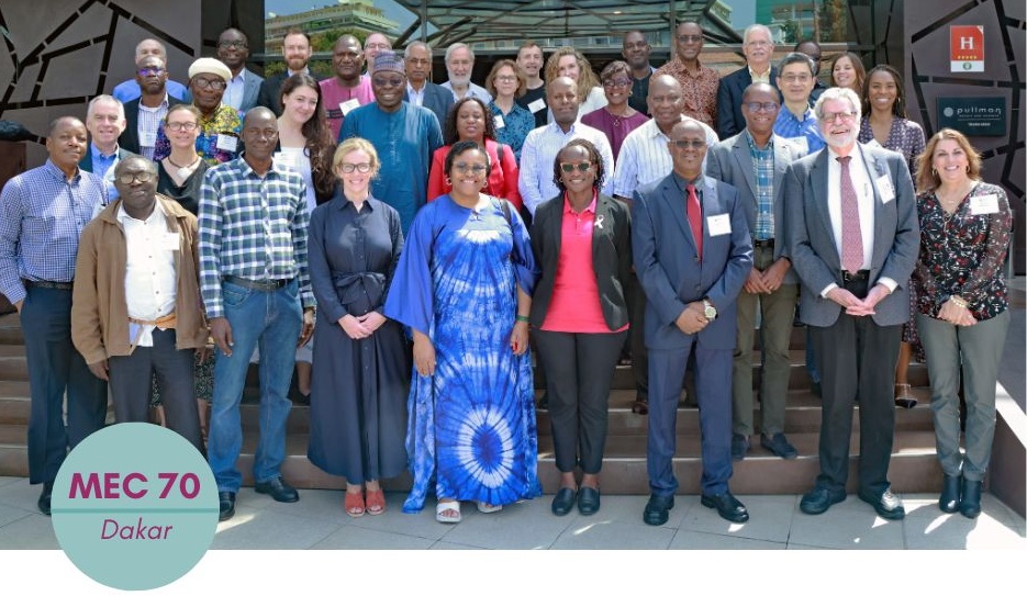Experts pose outdoors on a staircase for a group photo