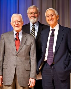 Photo of three men wearing neckties and smiling for the camera